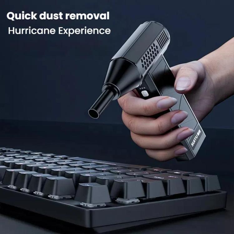 Handheld mini vacuum and air duster removing dust and crumbs from a car dashboard and vents.