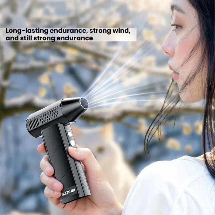 Portable cordless air duster vacuum cleaning dust from office desk and computer monitor.