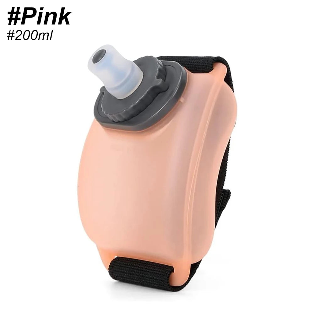 Pink handheld water bottle with black strap on a white background